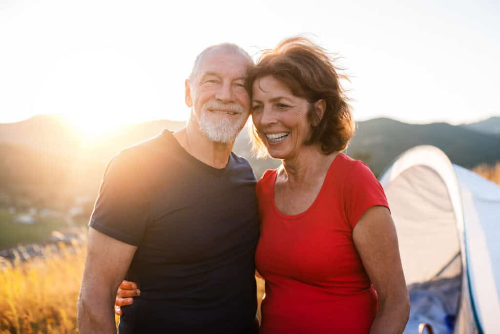 senior tourist couple standing in nature at sunset 2023 11 27 05 13 19 utc